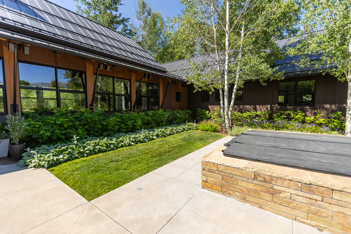 patio and covered fire feature courtyard lawn trees foundation planting beds