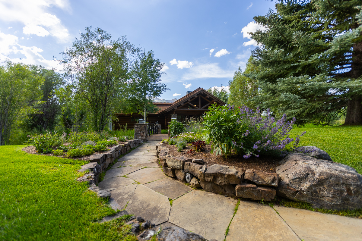 stone walkway retaining walls raised planters lawn trees